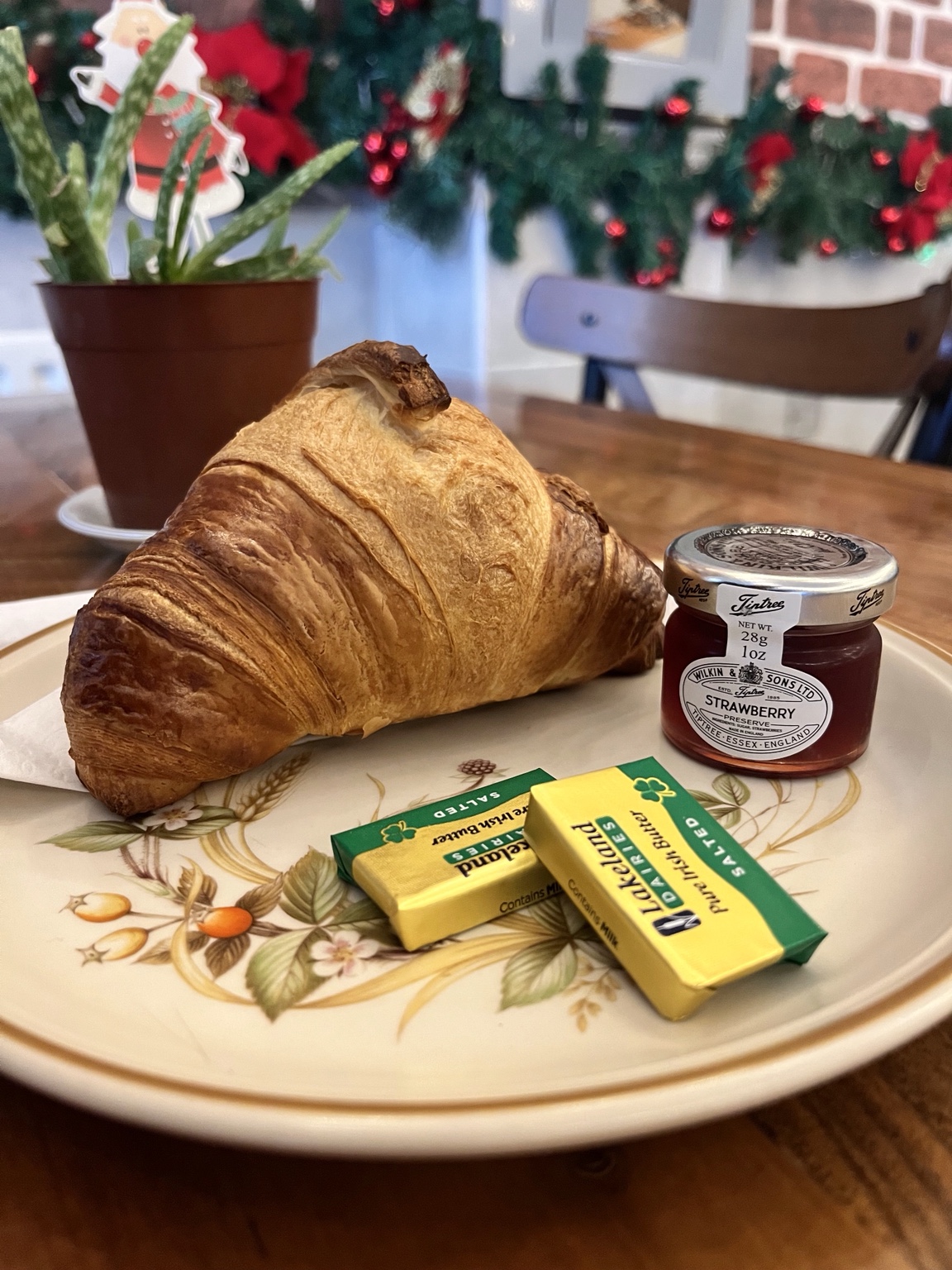Fresh croissant with butter and jam